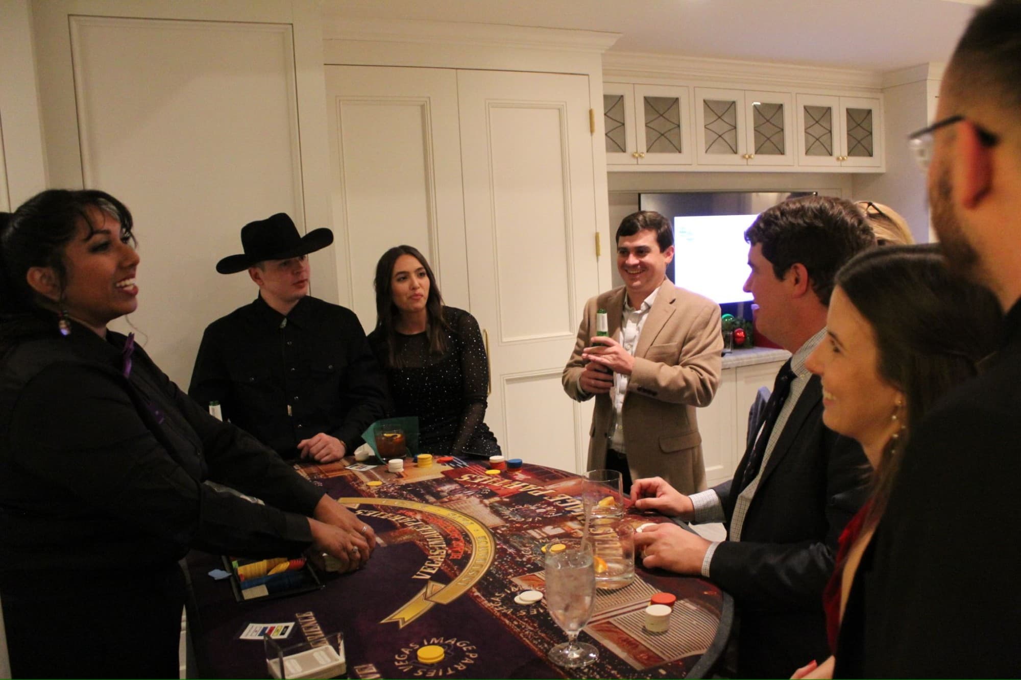 Team members at the blackjack table during the casino-night portion of the evening