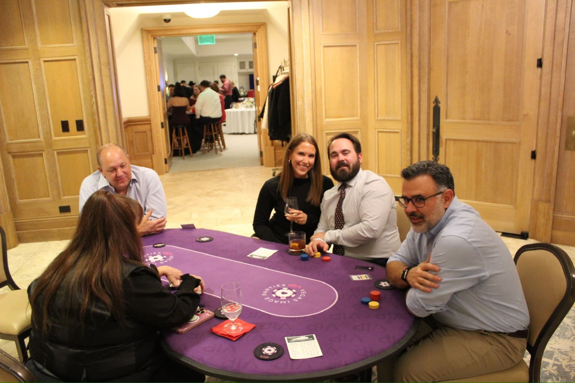 A poker hand in progress with team members around the table